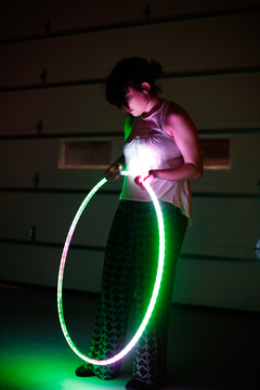 Nicole Coyne, 20, from Avon, New York plays with a glowing hula hoop during the band's set.
