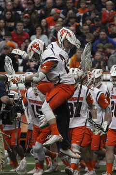 Syracuse attack Kevin Rice jumps shoulder-to-shoulder with a teammate during SU's 13-10 win over Johns Hopkins.