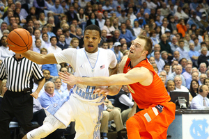 North Carolina's Nate Britt tries to get around Cooney on Monday night. Cooney had 28 points but it was Britt's four 3-pointers that helped guide UNC past Syracuse late.