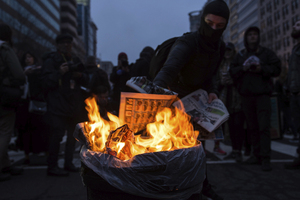Protesters set fire to a trash can in Washington, D.C. on Friday while protesting the election of President Donald Trump. The protests carried on throughout the day and turned violent at times.