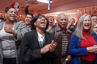 Evelyn Kinsty (center) celebrates with the news of President Obama's win at the Dan Maffei gathering.