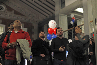 Viewers at the Maxwell 2012 Election Watch Party pause as CNN releases final polling announcements in New England states.