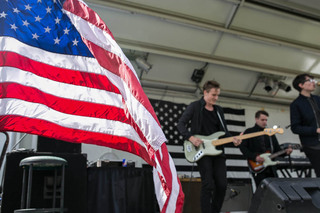 An American flag waves as Joywave performs during MayFest at Walnut Park. 