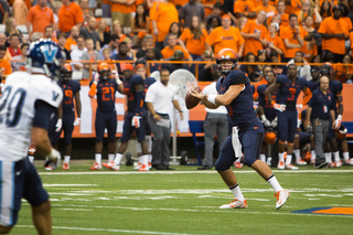 Austin Wilson, playing in place of the ejected Hunt, looks to throw a pass to his left.