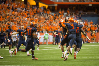 The Orange defense celebrates after getting a stop on a two-point conversion attempt to beat Villanova, as the SU bench pours onto the field.