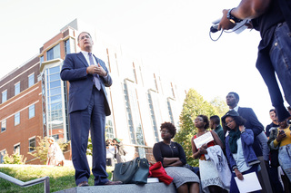 Eric Spina, vice chancellor and provost, speaks with protesters outside the Life Sciences building during the 