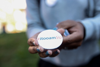 Stephanie Conn, a senior mathematics major, holds an #itooamSU button. The buttons were sold for two dollars each during the 