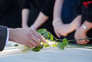 Elliott Russell, a bioengineering and biotechnology dual major and Remembrance Scholar, places his rose to represent Alexia Tsairis, the 20-year-old Syracuse victim who inspired the establishment of the Alexia Foundation. 