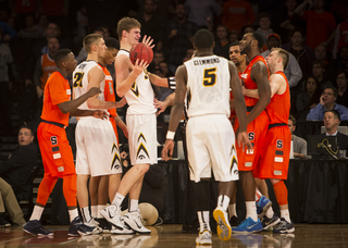 Cooney holds back Christmas as a scuffle ensues and Iowa's Adam Woodbury pleads his case.