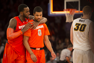Christmas wraps his arm around Gbinije's neck and gives some words of encouragement at the end of the first half.