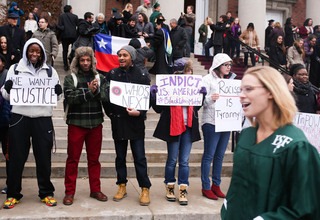 Protesters stand outside Hendricks Chapel as SUNY-ESF graduates file out of Hendricks Chapel.