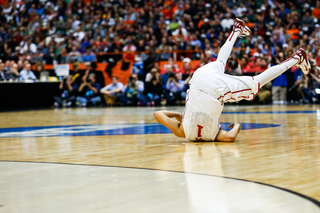 Oklahoma's Frank Booker falls backwards onto the court after attempting but missing a shot.