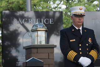 Syracuse Fire Department Chief Paul Linnertz stands in silence.