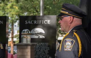 A Syracuse first responder looks on during Sunday's ceremony.