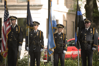 Members of the police and fire guard stand at attention during the 9/11 ceremony in downtown Syracuse.