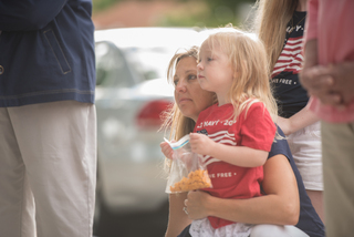 A mother and her daughter watch as the 9/11 ceremony in downtown Syracuse takes place on Sunday morning.